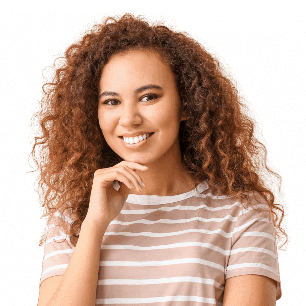 A young woman with curly hair in a brown and white striped tee shows off a straight, bright white smile.