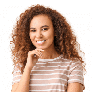A young woman with curly hair in a brown and white striped tee shows off a straight, bright white smile.