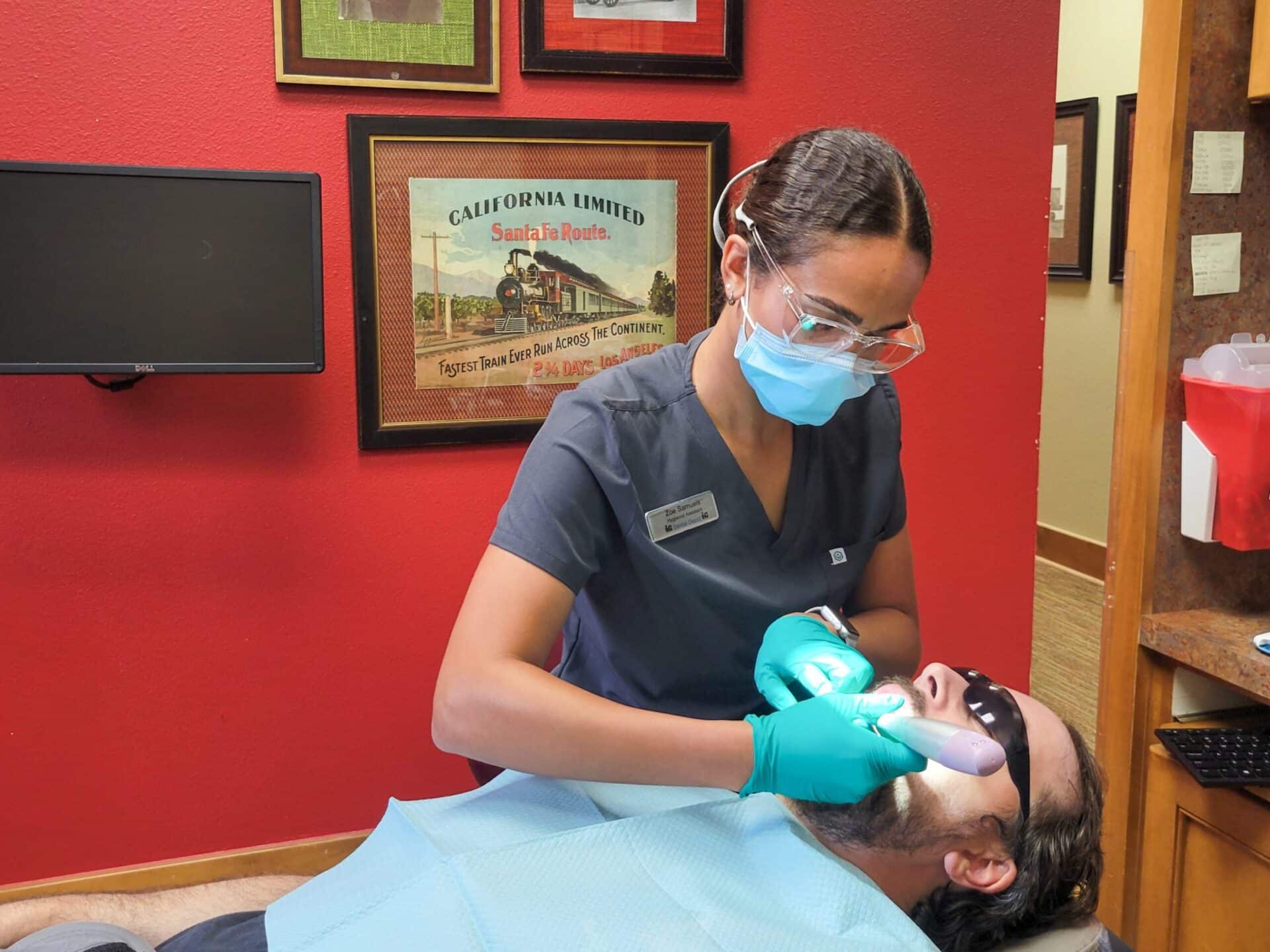 Dentist is performing a deep cleaning on a patient.