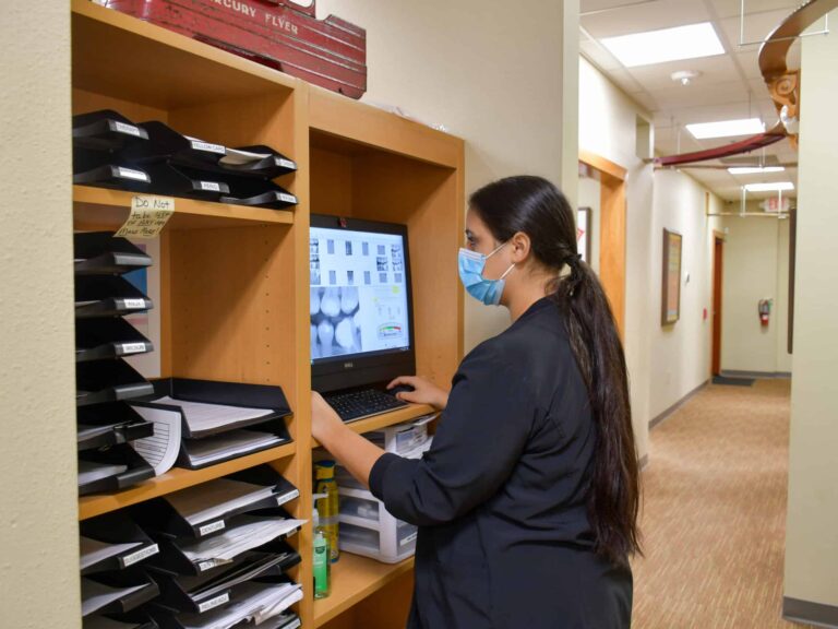 Dental Depot's Central Tulsa dentist reviews a patient's dental x-rays.