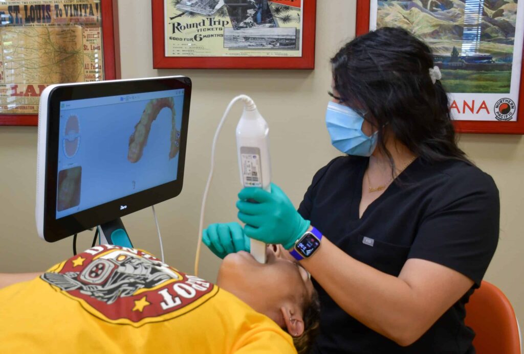 A dental assistant scans a patient's teeth at Dental Depot's Del City dental clinic