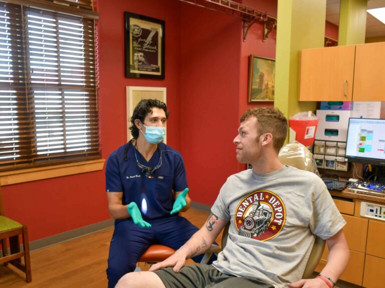 Dr. Keesh, Dentist in Tulsa talks to a patient about his dental health.