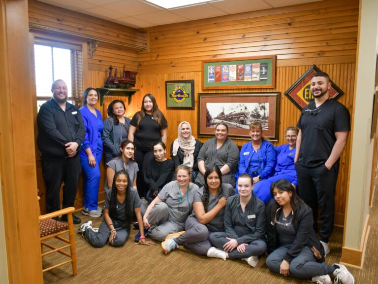 The full dental team at Dental Depot's Northwest OKC Dental clinic posing in the reception area