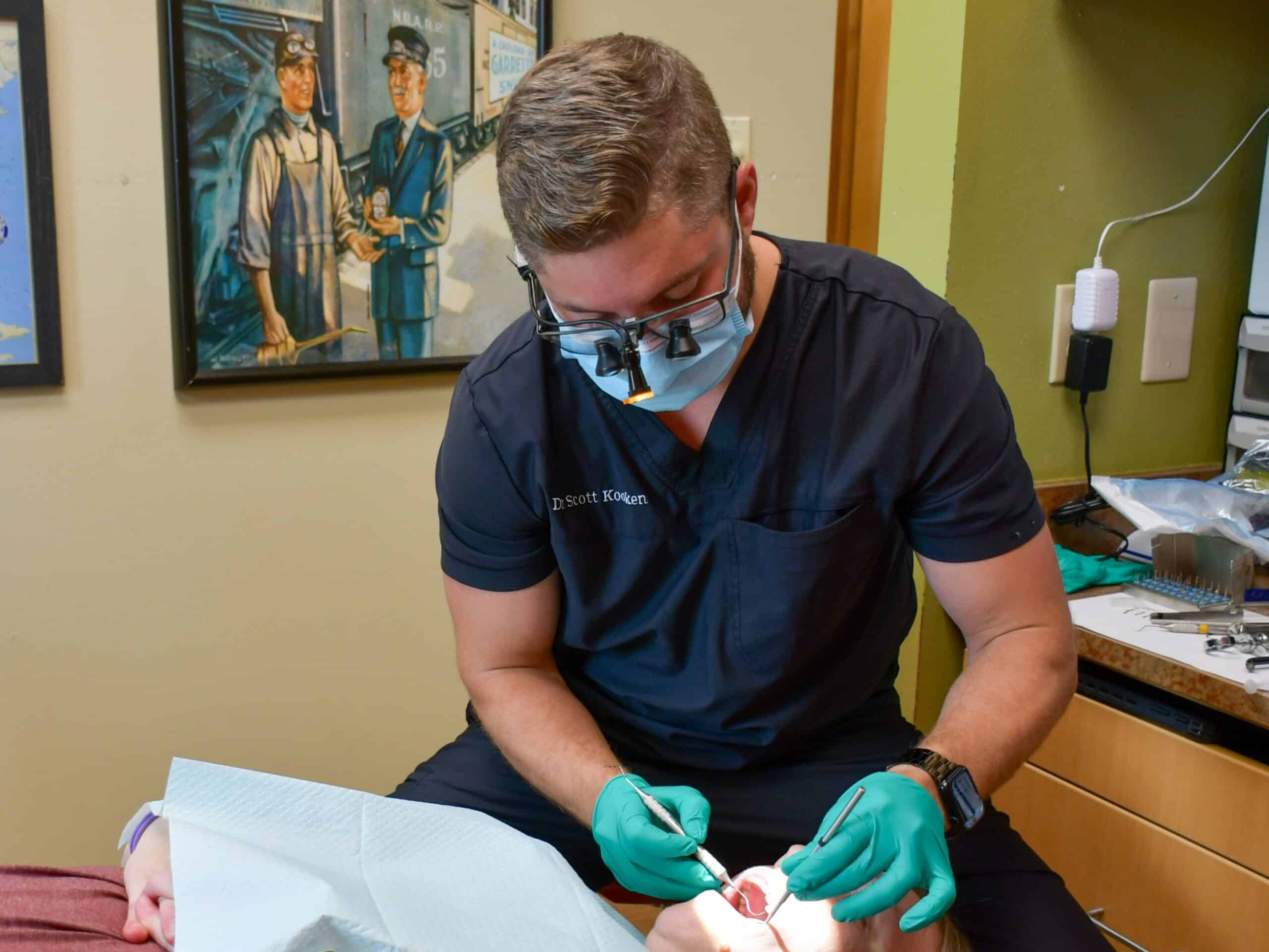 Dr. Kooken examines a dental patient.