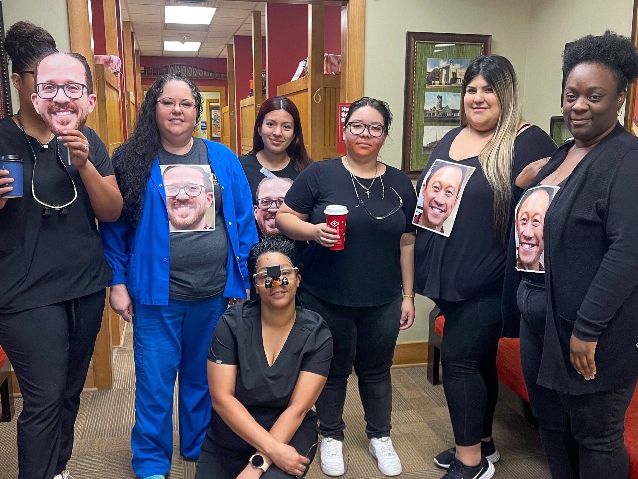 Dental Depot's North Penn dental team poses with pictures of Dr. Vu and Dr. Salous on their shirts.