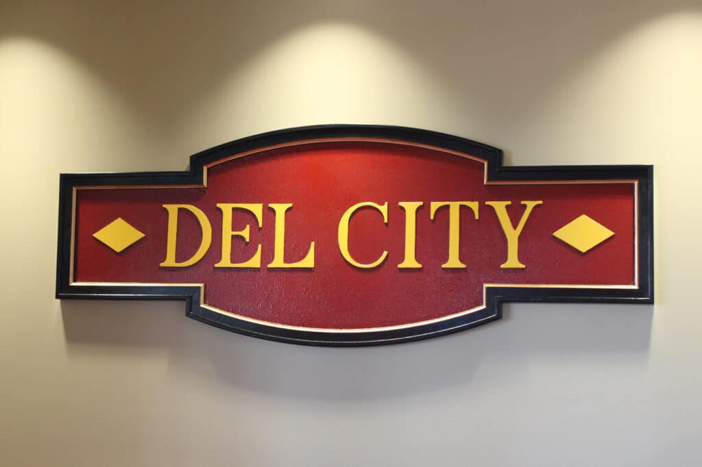 Close up image of the red Del City sign in the dental clinic's reception area.