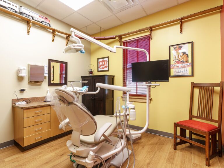 Dental operatory at Dental Depot's NW 63rd St Oklahoma City Dental office with dental chair and train themed pictures.