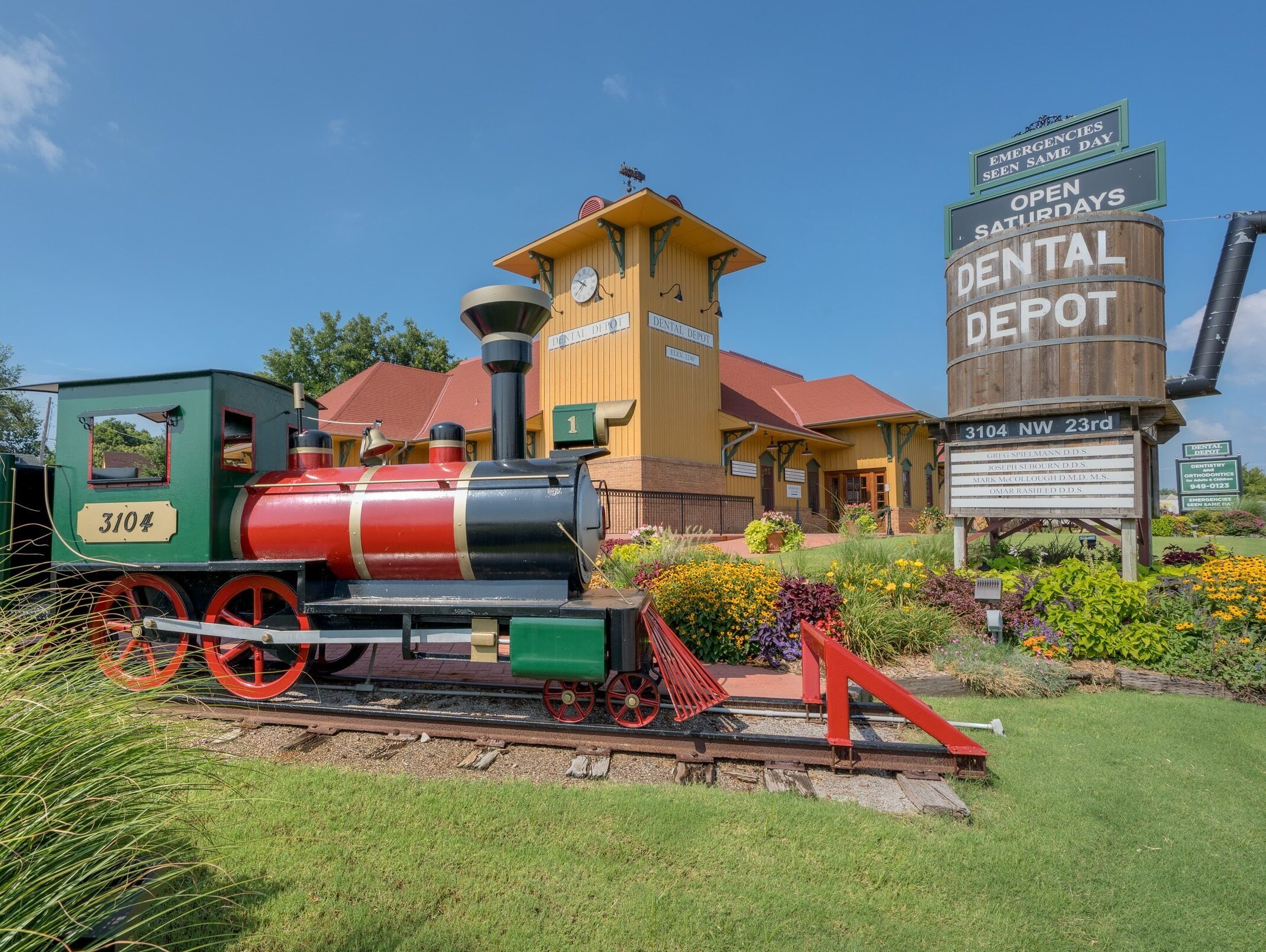 Dental Depot Central OKC Exterior view with model train and water tower in the foreground