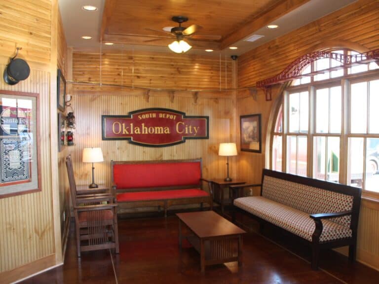 Interior view of the Dental Depot Southwest OKC waiting room with wooden walls, train themed signage, and an old time feel.