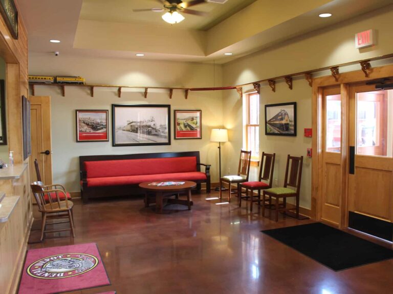 Dental Depot West Norman reception area with model train tracks and red furniture