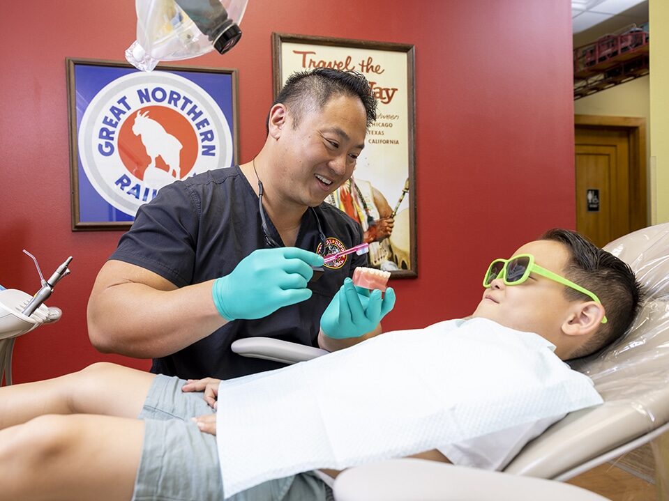 A young boy learns to properly brush at dental depot