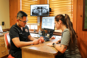 Dr. Tang in Yukon at Dental Depot consults an orthodontic patient.