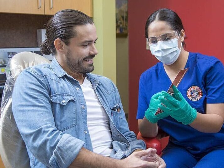 A man works with a dental hygienist at dental depot