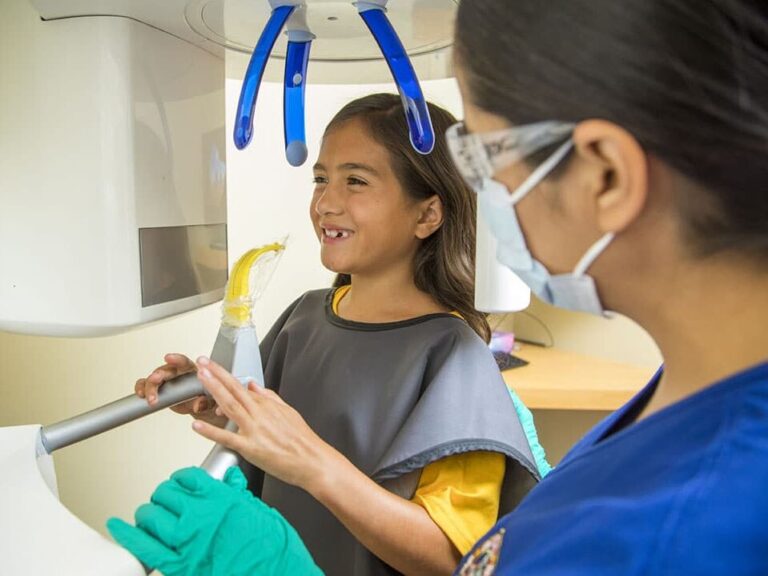 A girl gets ready for dental xrays at dental depot