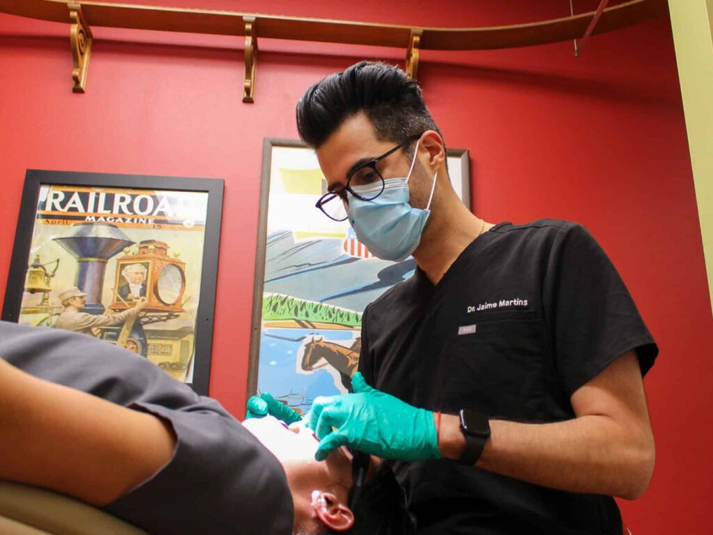 A dentist works on restoring a smile after facial trauma.