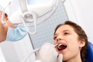 girl in dentist chair being worked on