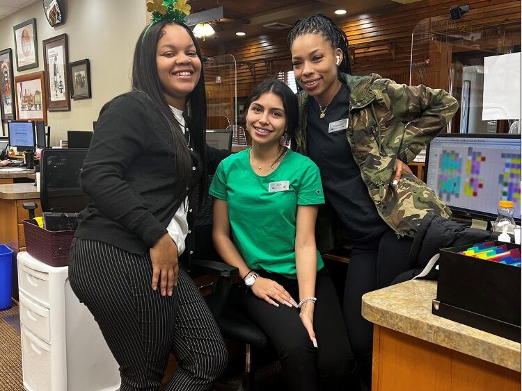 The Dental Depot dental team poses for a photo at the front desk of the dental clinic in Tulsa