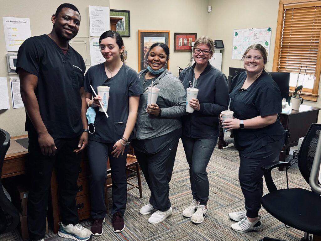 The Dental Depot dental team poses for a photo at in the office of the dental clinic in Tulsa